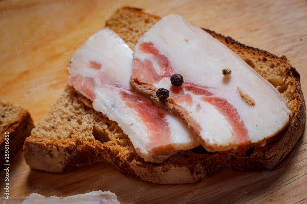 Lard sandwich with black bread and onions on a wooden board. Lard sandwich with black bread and onions on a wooden board.