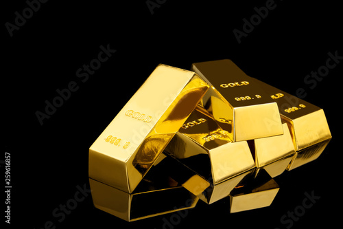 Shiny gold bars on black background. Space for text