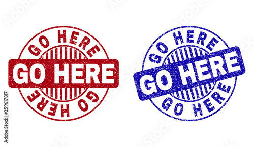 Grunge GO HERE round stamp seals isolated on a white background. Round seals with grunge texture in red and blue colors. Vector rubber imprint of GO HERE label inside circle form with stripes.