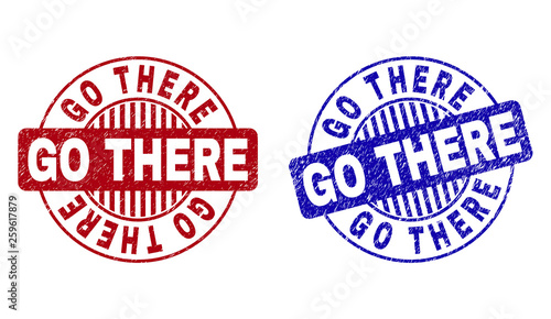 Grunge GO THERE round stamp seals isolated on a white background. Round seals with grunge texture in red and blue colors. Vector rubber imprint of GO THERE title inside circle form with stripes.