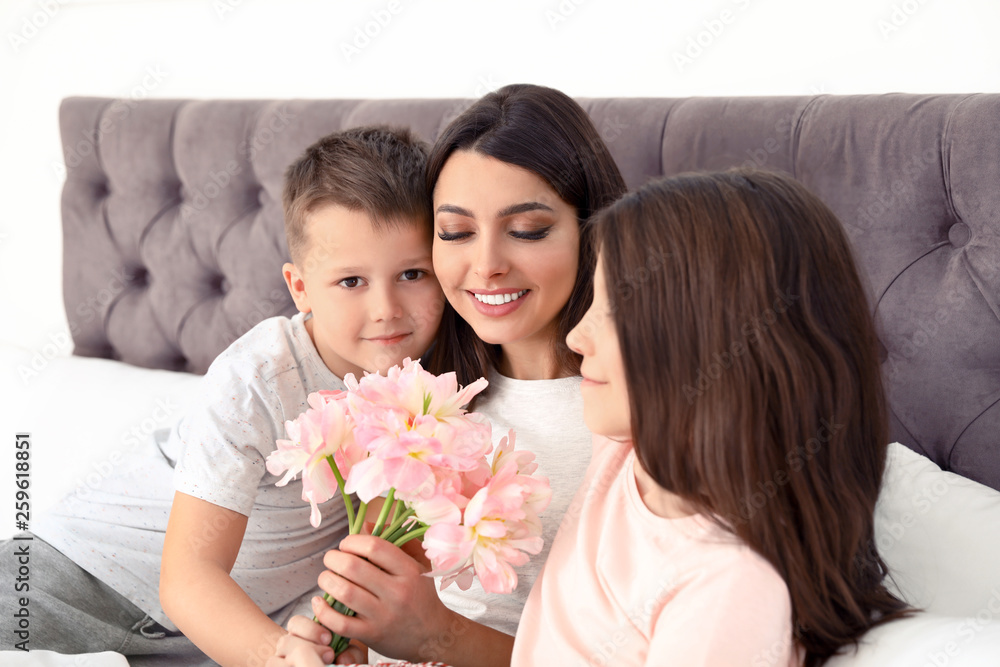 Son and daughter congratulating mom in bed. Happy Mother's Day
