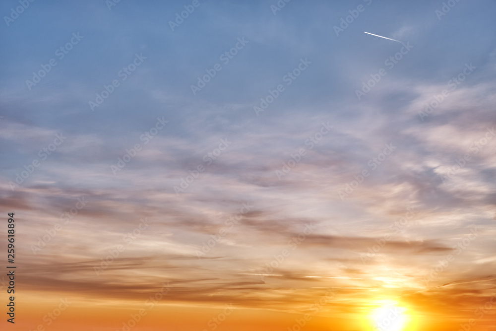 sunset sky nature landscape background with summer sun over horizon and beautiful sunrise light transition through clouds from blue to orange and yellow then red color scenic evening panorama view