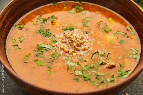 Traditional Georgian soup Kharcho with meat and rice on dark stone background