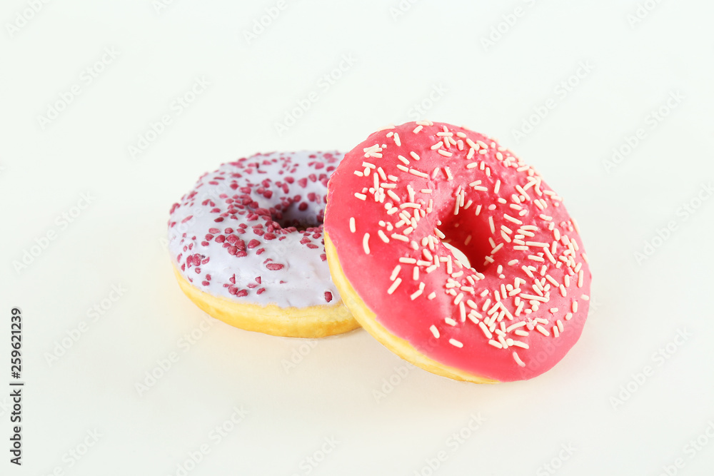 Vibrant composition of lush donut with colorful sprinkled icing, on bright background with a lot of copy space for text. Tasty but unhealthy food concept. Close up, flat lay, top view. Vibrant composition of lush donut with colorful sprinkled icing, on bright background with a lot of copy space for text. Tasty but unhealthy food concept. Close up, flat lay, top view.