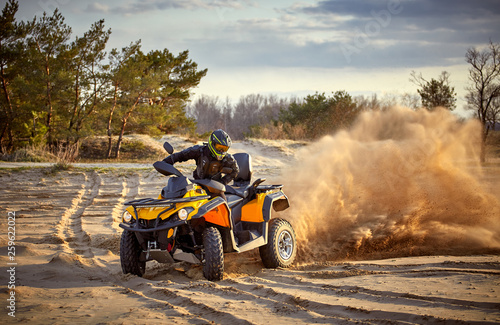 Racing in the sand on a four-wheel drive quad. photo