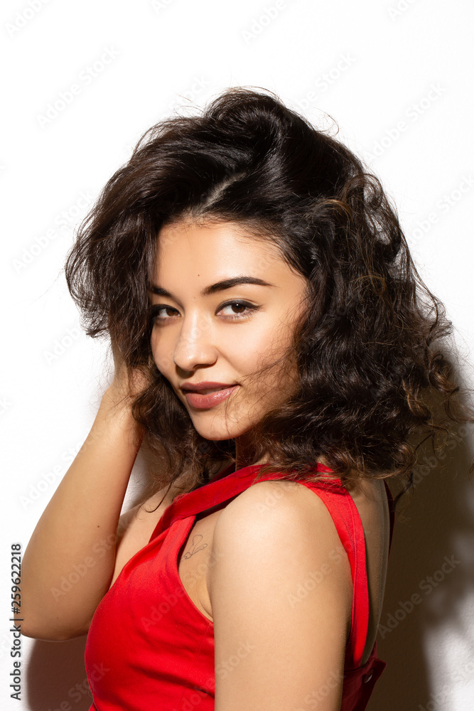 Asian beautiful model on white background in red top Asian beautiful model on white background in red top