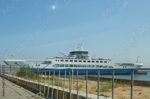 White ship on the pier near the sea shore.