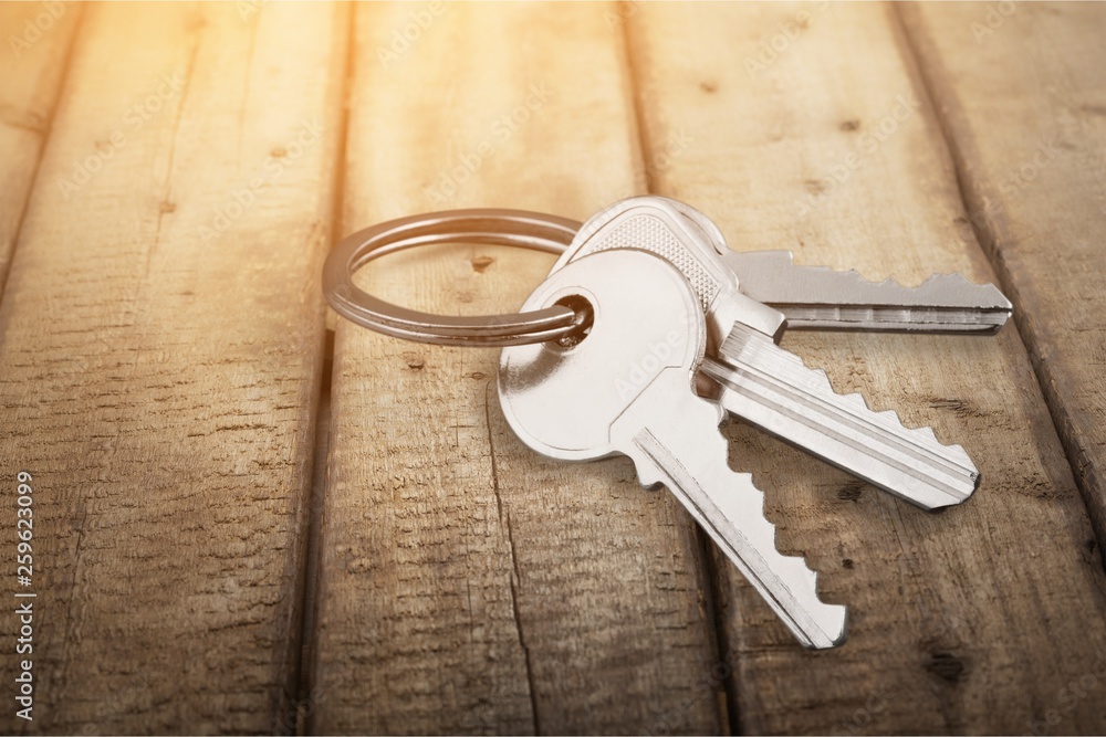 House keys with house figure on background House keys with house figure on background