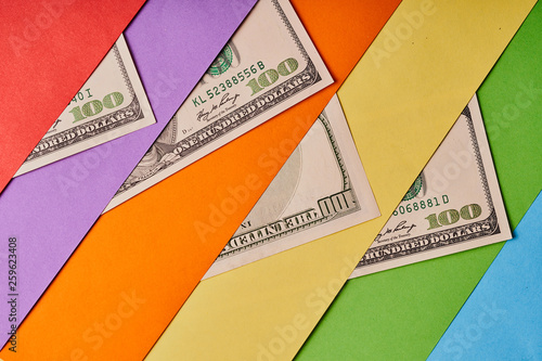 A few American dollars on a colored paper background