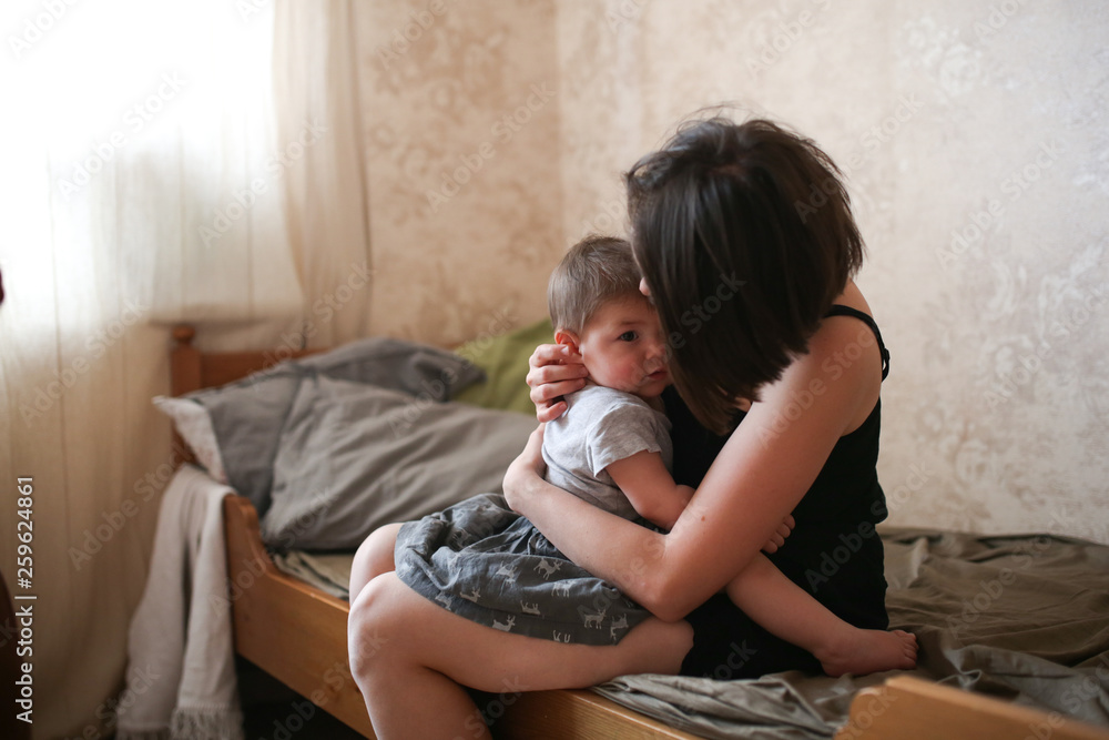 young mother brunette kiss and hugs baby daughter young mother brunette kiss and hugs baby daughter