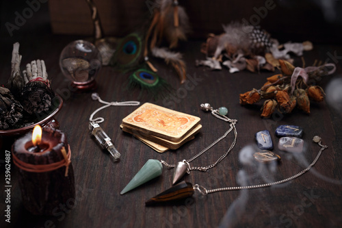 Faerie accessories. A deck of old divination cards and a stone pendulum.