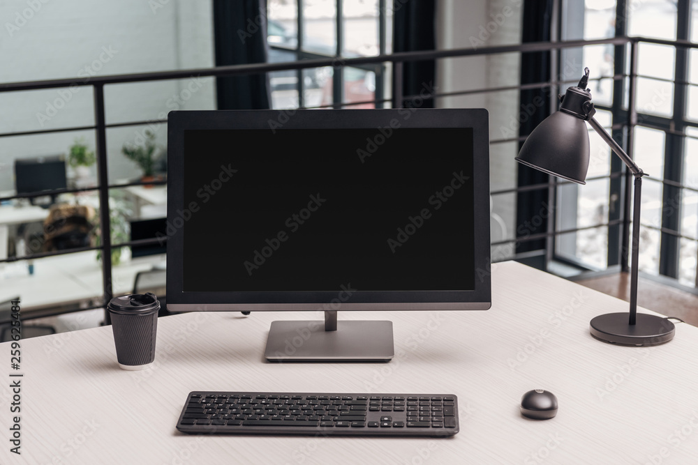 Fototapeta premium modern workplace with computer, coffee to go and lamp in office