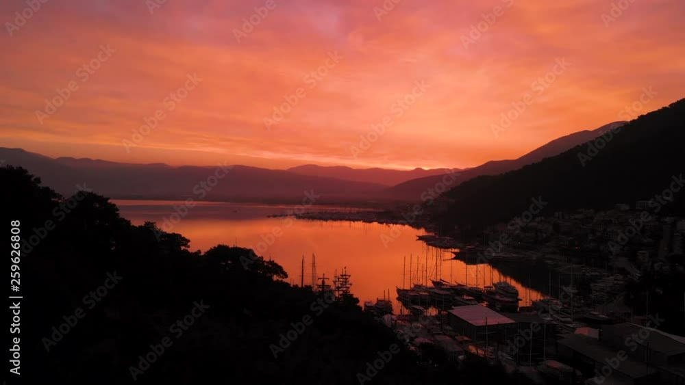 Aerial panning over a tranquil harbor at sunrise on a calm day Aerial panning over a tranquil harbor at sunrise on a calm day
