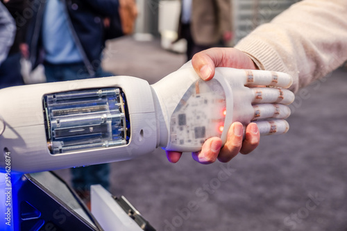 Human hand and robot's as a symbol of connection between people and artificial intelligence technology photo