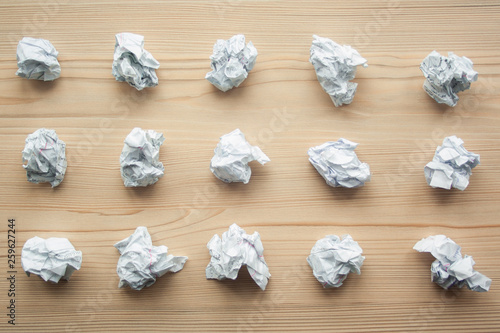 Many crumpled white paper balls from above background. Texture of crumpled paper balls. Crumpled paper as brainstorming, creativity concept, mistakes and creation symbol.