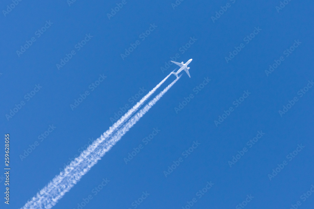Airplanes leaving contrail trace on a clear blue sky. Airplanes leaving contrail trace on a clear blue sky.