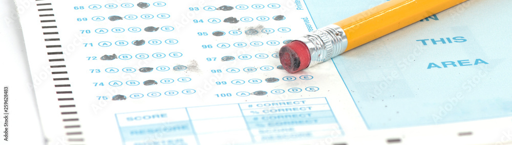 Standardized test form with pencil and eraser with a shallow depth of field and copy space - obrazy, fototapety, plakaty 