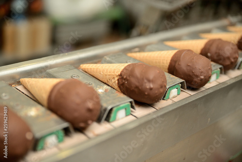 The conveyor automatic lines for the production of ice cream. Production of ice-cream at milk factory