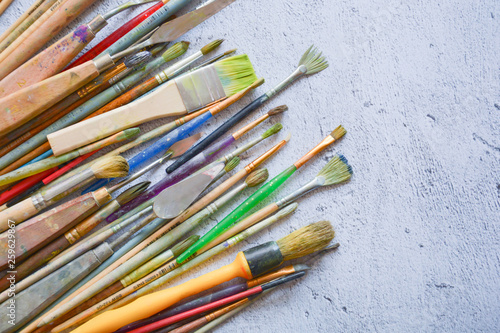 brushes and painter's hands on a plane