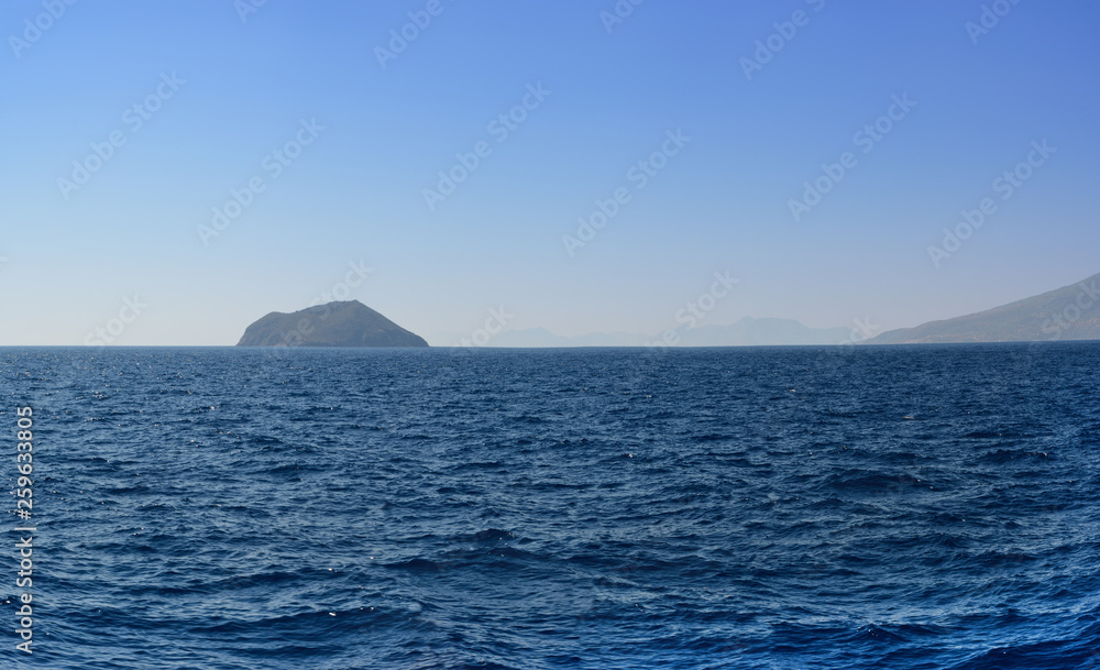 Panorama of the Aegean Sea overlooking the next islands and mountains in the summer evening after a decline. it is sewed from four vertical pictures