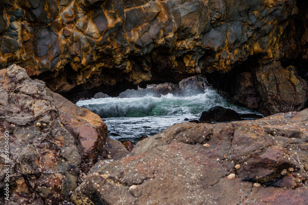 California sea cave with waves breaking inside