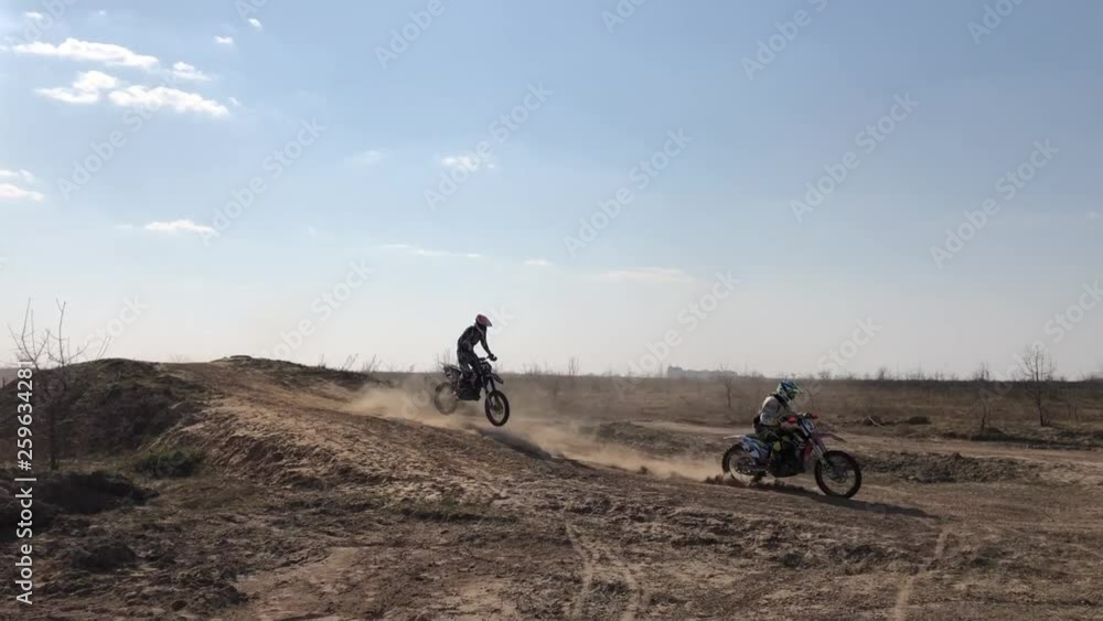 Motocross. Athletes ride motorcycles. A professional motocross biker rides his Fmx motorcycle through the dunes on a sandy road Motocross. Athletes ride motorcycles. A professional motocross biker rides his Fmx motorcycle through the dunes on a sandy road