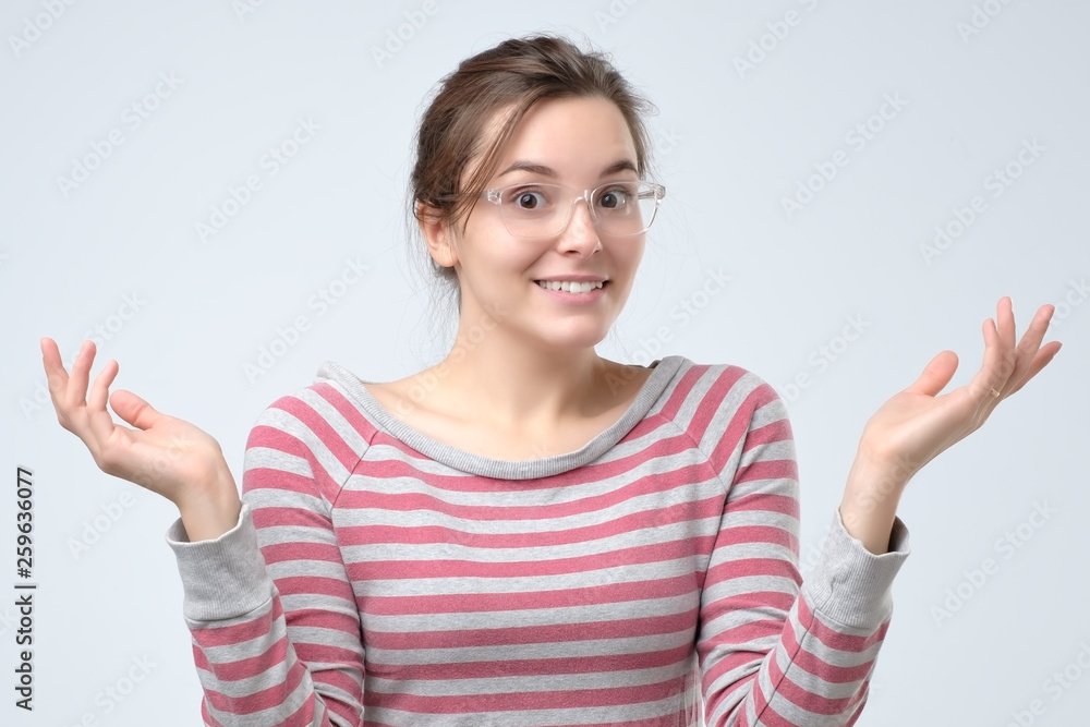 Woman shrugging hands and expressing confusion, not having any clue Woman shrugging hands and expressing confusion, not having any clue