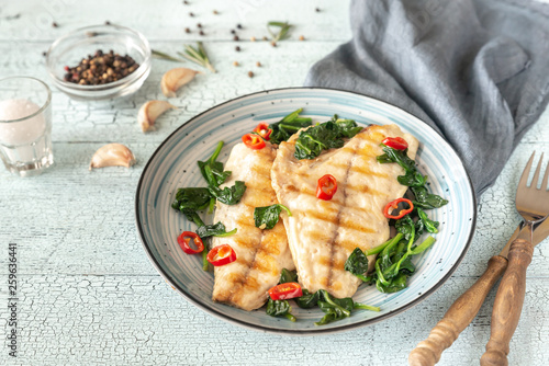 Grilled sea bream fish fillet with spinach