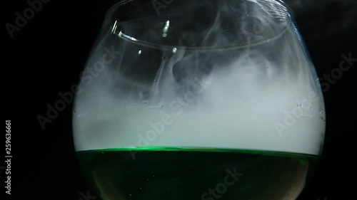 Absinthe glass smoke wooden table hd footage nobody  photo