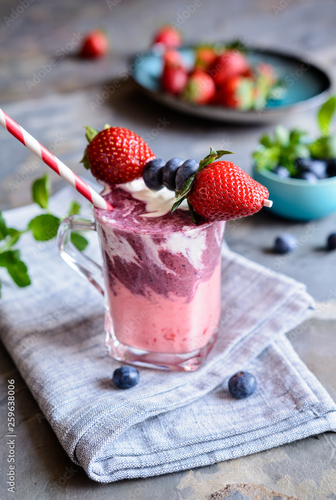 Strawberry and blueberry smoothie with yogurt, decorated with fruit skewer Strawberry and blueberry smoothie with yogurt, decorated with fruit skewer
