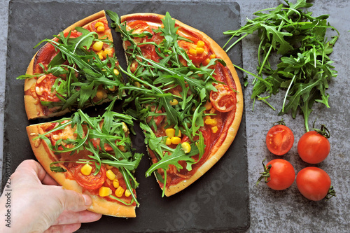 Vegan pizza with fresh arugula, corn and tomatoes. Healthy pizza.