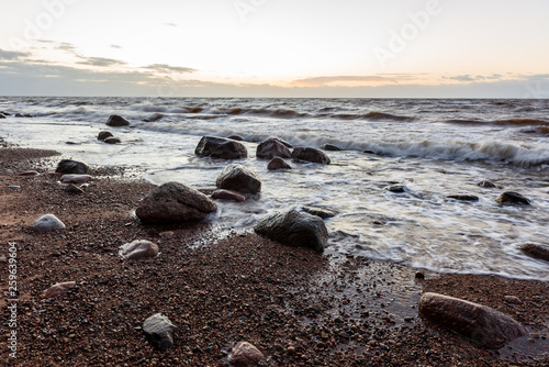 storm weather on the beach by rocky sea shore