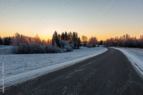 snowy winter road covered in ice and snow © Martins Vanags