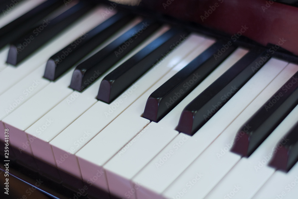 Classical piano keyboard black and withe, musical keys and instrument. Music concept background. Close up, selective focus