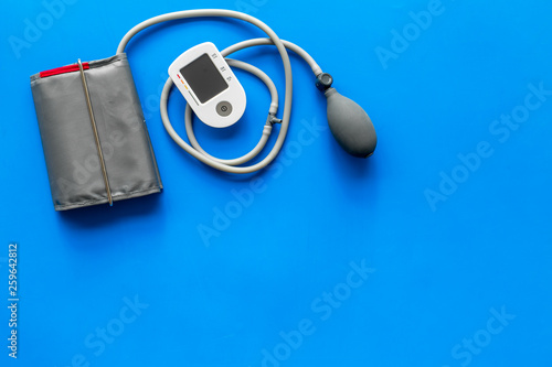 tonometer for heart diseases diagnostic on blue background top view mockup