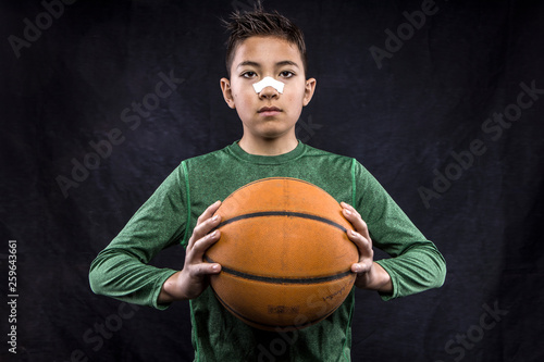 Boy holding a basketball.
