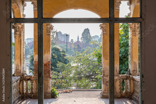 The Mansion or Villa Bodega  a half-ruined colonial-era building  1910-1920s  in Phnom Penh city center. The Interior and a view of National Museum of Cambodia from the 2nd floor. February 2019.