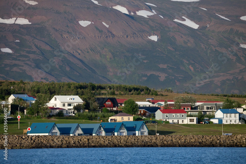  Icelandic village with colored houses on the shore of the fjord