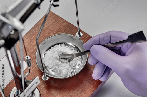 Pharmacist or scientist preparing medicine using precision weighing photo