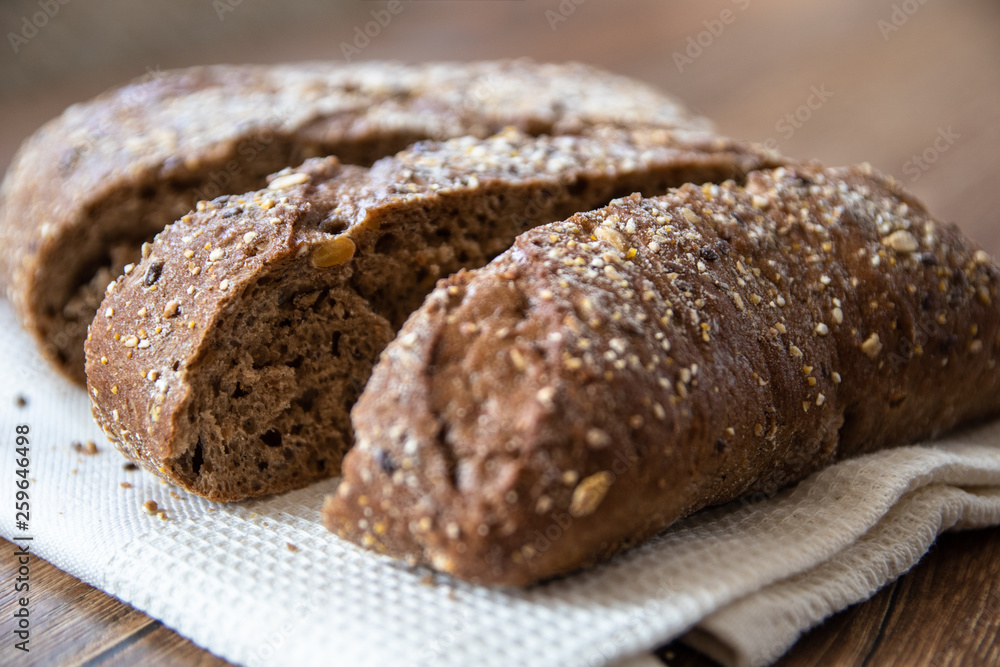Homemade healthy freshly baked organic whole grain bread with healthy seeds on wooden table