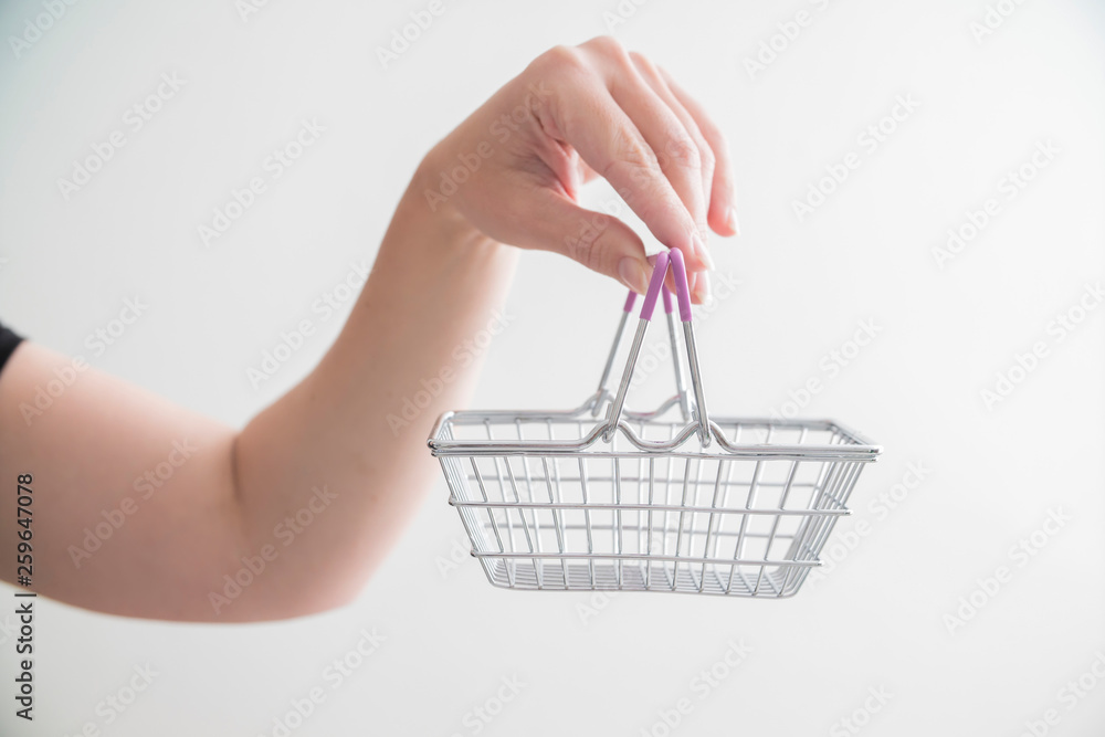 Fototapeta premium food basket in hand as a symbol of shopping and price