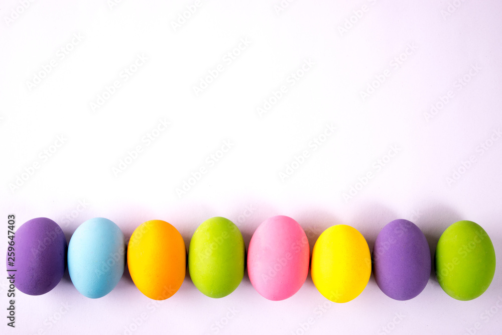 Happy Easter. Easter eggs concept. Row Easter eggs on white paper background. Happy Easter. Easter eggs concept. Row Easter eggs on white paper background.