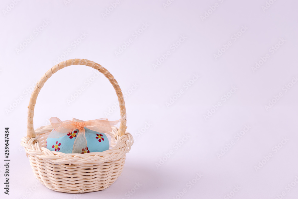 Happy Easter. Easter eggs concept. Closeup Easter eggs in the basket on white paper background. Happy Easter. Easter eggs concept. Closeup Easter eggs in the basket on white paper background.