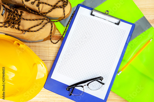 High visibility vest with work boots and yellow hard hat