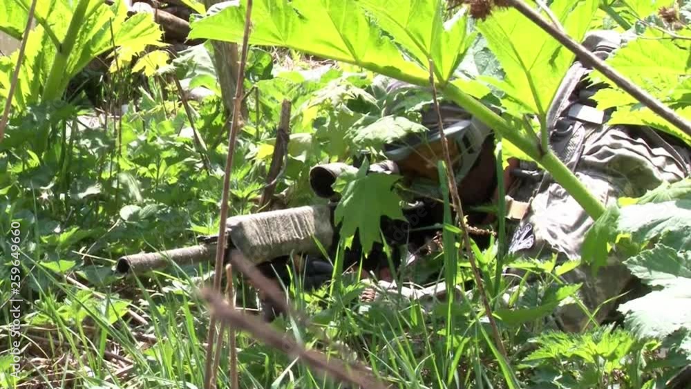 Airsoft player in military uniform with weapon plays in forest. Airsoft player in military uniform with weapon plays in forest.