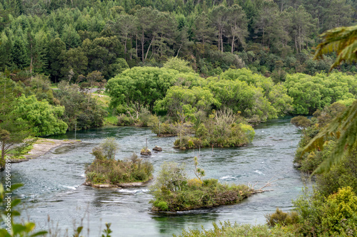 View of Waikato River with Small Islands and Forest along Huka Falls Hiking Trail in New Zealand