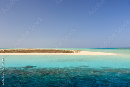 Fototapeta Naklejka Na Ścianę i Meble -  Island sea sky view with palms and beautiful mountains on the background horizon in the sunset time. Beautiful picturesque landscape at evening blue hour. Africa, Egypt, Hurghada, El Gouna, Red Sea
