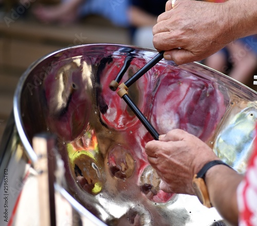 Caribbean Steel pan drum player with sticks photo