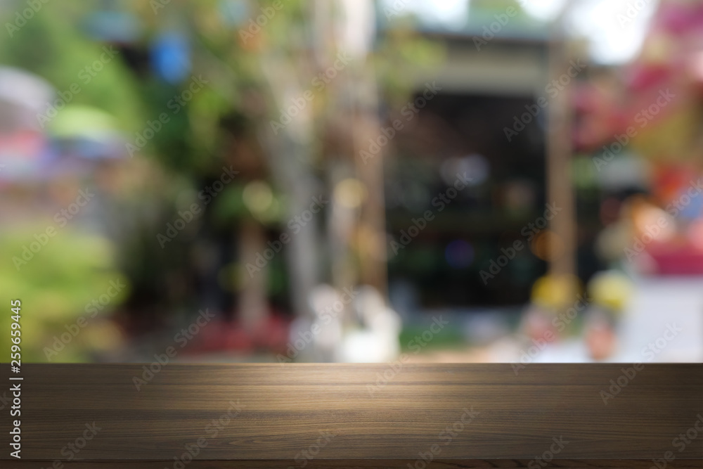 Empty dark wooden table in front of abstract blurred bokeh background of restaurant . can be used for display or montage your products.Mock up for space.