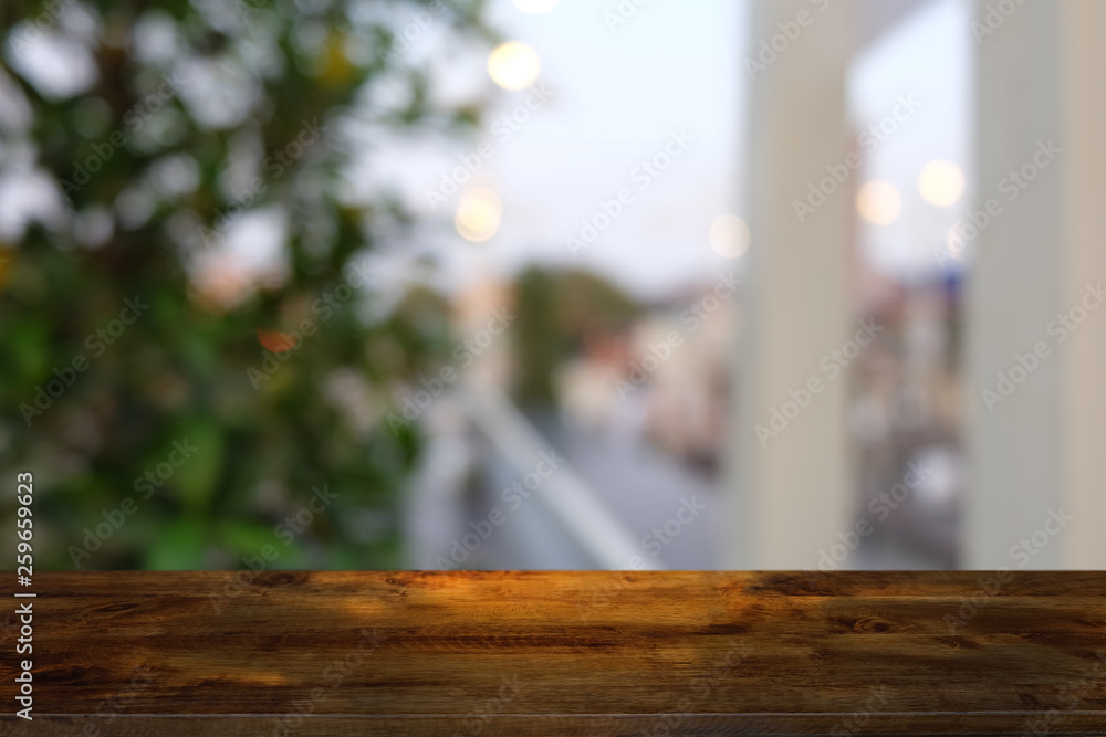 Empty dark wooden table in front of abstract blurred bokeh background of restaurant . can be used for display or montage your products.Mock up for space. Empty dark wooden table in front of abstract blurred bokeh background of restaurant . can be used for display or montage your products.Mock up for space.